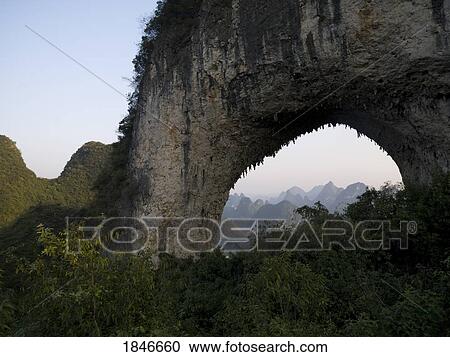 Natural Arch In Mountains; Yangshuo, China View Large Photo Image Stock Image - Natural Arch In Mountains; Yangshuo, China. Fotosearch