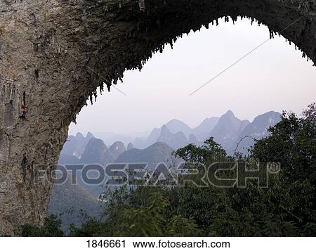 Natural Arch In Mountains; Yangshuo, China View Large Photo Image Stock Image - Natural Arch In Mountains; Yangshuo, China. Fotosearch