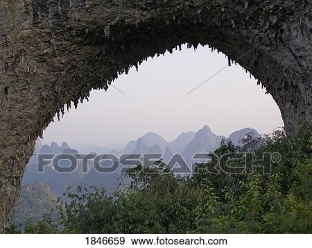 Natural Arch In Mountains; Yangshuo, China View Large Photo Image Stock Photo - Natural Arch In Mountains; Yangshuo, China. Fotosearch
