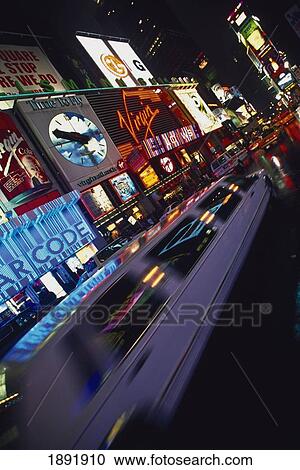 Stock Image - Neons And Cars In Times Square, Blurred Motion. Fotosearch