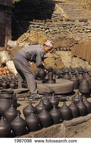 Nepal, Bhaktapur, Potter's Square, Local Man Shaping Clay Pots, Finished Pots Out On Display. View Large Photo Image Stock Photo - Nepal, Bhaktapur, Potter's Square, Local Man Shaping Clay Pots, Finished Pots Out On Display.. Fotosearch