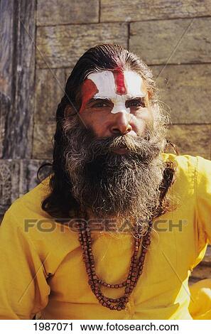 Nepal, Kathmandu, Pashupatinath Temple, Hindu Holy Man Wearing Yellow Robe, Long Hair And Painted Face. Editorial Use Only. View Large Photo Image Stock Image - Nepal, Kathmandu, Pashupatinath Temple, Hindu Holy Man Wearing Yellow Robe, Long Hair And Painted Face. Editorial Use Only.. Fotosearch