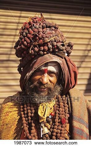 Nepal, Kathmandu, Smiling Hindu Holy Man Wearing Necklaces And Headdress, Bright Sunlight. Editorial Use Only. View Large Photo Image Stock Image - Nepal, Kathmandu, Smiling Hindu Holy Man Wearing Necklaces And Headdress, Bright Sunlight. Editorial Use Only.. Fotosearch