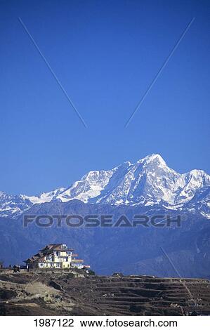 Stock Image - Nepal, Nagarkot, Hotel Chautari Keyman On Hillside, Central Himalayan Mountains In Background.. Fotosearch