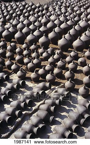 Stock Image - Nepal, Potter's Square; Bhaktapur, Vases of various sizes lined up in rows potters. Fotosearch