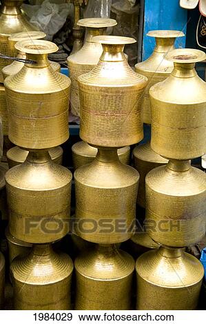 Stock Photo - Nepal, Stack of shiny brass pots in Durbar Square; Kathmandu. Fotosearch