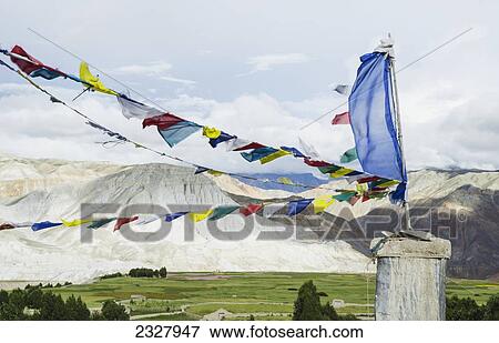Stock Photo - Nepal, Upper Mustang, Prayer flags and symbols at top of King's Palace; Lo Manthang. Fotosearch