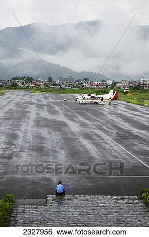 Stock Photograph - Nepal, View of airplanes at airport; Pokhara. Fotosearch