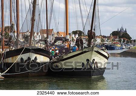 Stock Image - Netherlands, Zealand, Boats docked in a busy harbor; Zierikzee. Fotosearch