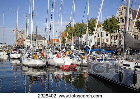 Stock Image - Netherlands, Zealand, Boats in harbour; Veere. Fotosearch