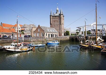 Picture - Netherlands, Zealand, Boats in the harbor with buildings by the waterfront; Zierikzee. Fotosearch