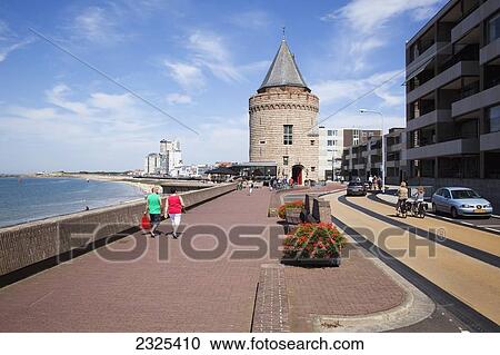 Netherlands, Zealand, Pedestrians walking on promenade along ocean with buildings in town; Vlissingen View Large Photo Image Stock Image - Netherlands, Zealand, Pedestrians walking on promenade along ocean with buildings in town; Vlissingen. Fotosearch