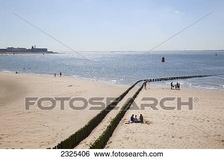 Netherlands, Zealand, People on beach with view of town along coast in distance; Vlissingen View Large Photo Image Stock Photograph - Netherlands, Zealand, People on beach with view of town along coast in distance; Vlissingen. Fotosearch