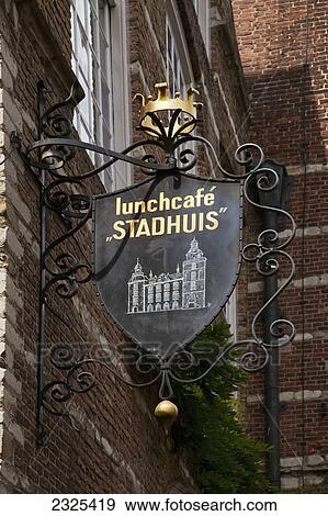 Stock Photo - Netherlands, Zealand, Sign for restaurant mounted on brick building; Goes. Fotosearch