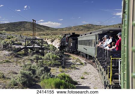 Nevada Northern Railway train takes passengers on flat car into the hills; Ely, Nevada, United States of America View Large Photo Image Stock Photography - Nevada Northern Railway train takes passengers on flat car into the hills; Ely, Nevada, United States of America. Fotosearch
