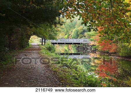New England, Massachusetts, Blackstone Valley, Pathway and bridge near river. View Large Photo Image Stock Photo - New England, Massachusetts, Blackstone Valley, Pathway and bridge near river.. Fotosearch