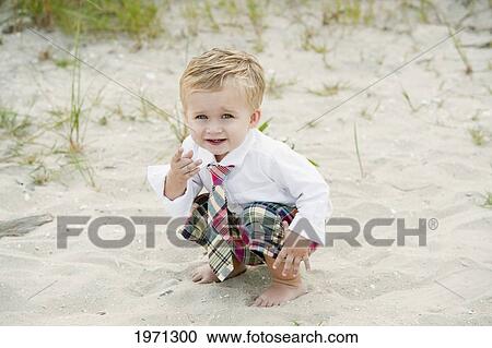 Stock Image - New Jersey, Ocean City, Young Boy Playing Along The Beach.. Fotosearch