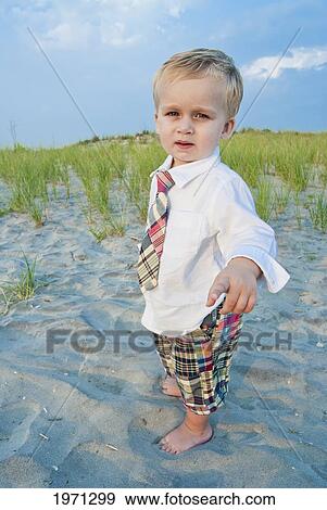 Stock Photo - New Jersey, Ocean City, Young Boy Playing Along The Beach.. Fotosearch