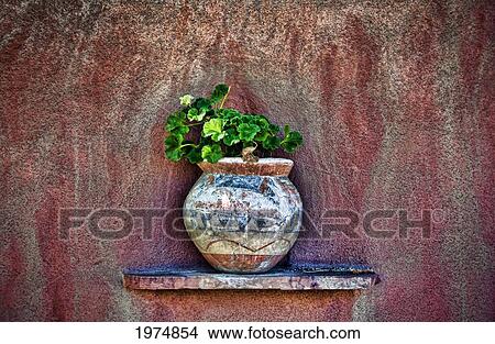New Mexican Wall Sconces, New Mexico, Rustic Detail Of Potted Plant Against Adobe Wall. View Large Photo Image Picture - New Mexican Wall Sconces, New Mexico, Rustic Detail Of Potted Plant Against Adobe Wall.. Fotosearch