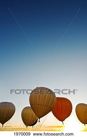 Stock Photo - New Mexico, Albuquerque, Hot Air Balloons Against Bright Afternoon Sky.. Fotosearch