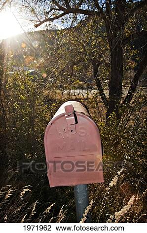 Stock Image - New Mexico, Jemez Springs, Mailbox At Residence Among Desert Weeds, Afternoon Sunlight.. Fotosearch