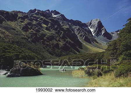 Stock Image - New Zealand, Fiordlands National Park, Routeburn Track, Lake And Mountains.. Fotosearch