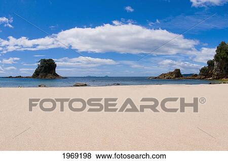 Stock Photo - New Zealand, North Island, Coromandel, Otara Bar, White Sandy Beach With Small Rock Island.. Fotosearch