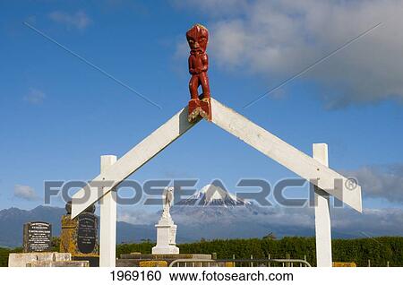 New Zealand, North Island, Taranaki, Maori Graveyard With A Wooden Gateway With Red Carving Figurine In Small Village, Okato. View Large Photo Image Stock Image - New Zealand, North Island, Taranaki, Maori Graveyard With A Wooden Gateway With Red Carving Figurine In Small Village, Okato.. Fotosearch