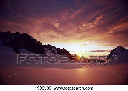 Stock Photograph - New Zealand, South Island, Mount Cook, Sunset Atop Glacier, Reflections A55B. Fotosearch
