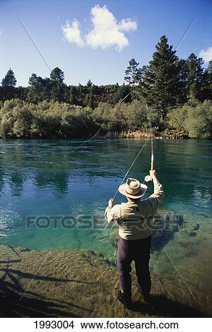 Picture - New Zealand, Taupo, Kuka Lodge, Man Fly Fishing On Waikato River. For Editorial Use Only.. Fotosearch