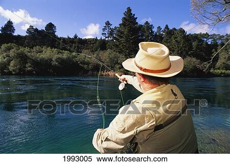New Zealand, Taupo, Kuka Lodge, Man Fly Fishing On Waikato River. For Editorial Use Only. View Large Photo Image Stock Photography - New Zealand, Taupo, Kuka Lodge, Man Fly Fishing On Waikato River. For Editorial Use Only.. Fotosearch