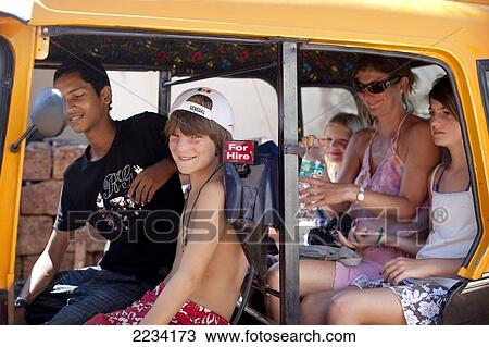 Stock Image - Nicola Rollason take a rickshaw with her kids, Max, Savanna and Isabella on Patnum Beach, Goa, India.. Fotosearch