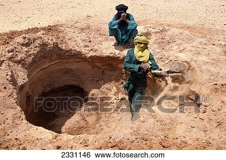 Niger, Men digging well in sand; Tenere Desert View Large Photo Image Stock Photograph - Niger, Men digging well in sand; Tenere Desert. Fotosearch