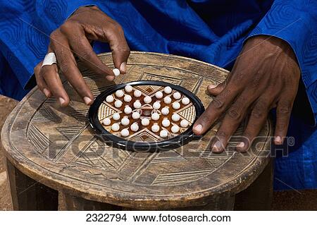 Niger, Northern Niger, Air Region, Tuareg man playing Solitaire traditional game; Agadez View Large Photo Image Picture - Niger, Northern Niger, Air Region, Tuareg man playing Solitaire traditional game; Agadez. Fotosearch
