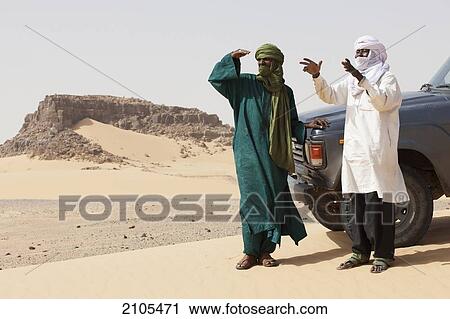 Niger, Sahara Desert, Escarpment of Tiguidit; Agadez Region, Tuareg men checking route View Large Photo Image Stock Image - Niger, Sahara Desert, Escarpment of Tiguidit; Agadez Region, Tuareg men checking route. Fotosearch