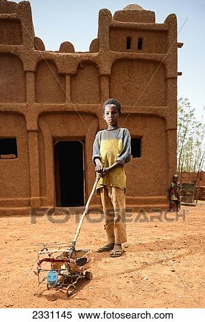 Niger, Tahoa Region, Young boy with home made toy; Yaama Village View Large Photo Image Stock Photography - Niger, Tahoa Region, Young boy with home made toy; Yaama Village. Fotosearch