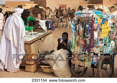 Niger, Tuareg men shopping for garments at Housa trader's stall. Agadez's livestock market; Agadez View Large Photo Image Picture - Niger, Tuareg men shopping for garments at Housa trader's stall. Agadez's livestock market; Agadez. Fotosearch
