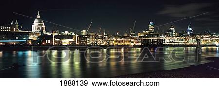 Stock Photo - Night Shot Of The City Of London, Viewed From The Southbank, With St. Paul's Cathedral On The Left And The Millennium Bridge On The Right.. Fotosearch