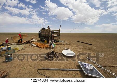 Picture - Nomad family dismantling a Mongolian ger (yurt) and loading it into a truck, Gobi Gurvansaikhan National Park,? mnÃƒÆ’Ã‚Â·govi Province, Mongolia. Fotosearch