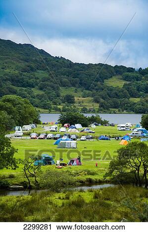 Stock Image - North Wales. UK, Snowdonia National Park, Nantgwynant, river and lake; Llyn Gwynant Campsite, surrounded by hillsides, Colorful tents & caravans in the valley. Fotosearch