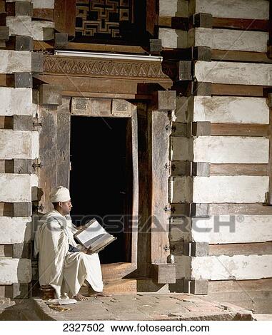 Northen Ethiopia, Ethiopian Orthodox priest reading bible in front of Yemrehanna Krestos Church; Lalibela View Large Photo Image Stock Image - Northen Ethiopia, Ethiopian Orthodox priest reading bible in front of Yemrehanna Krestos Church; Lalibela. Fotosearch