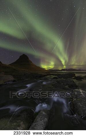 Northern Lights (Aurora Borealis) Over Kirkjufell In The Town Of Grundarfjorthur, Snaefellsness Peninsula; Grundarfjorthur, Iceland View Large Photo Image Stock Photo - Northern Lights (Aurora Borealis) Over Kirkjufell In The Town Of Grundarfjorthur, Snaefellsness Peninsula; Grundarfjorthur, Iceland. Fotosearch