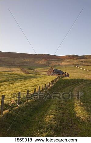 Stock Photo - Northumberland, England; A Farm Structure And A Fence Around A Field. Fotosearch