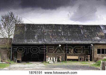Stock Image - Northumberland, England; A Wooden Building With Open Windows And An Opening For The Entrance. Fotosearch