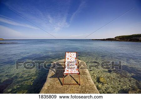 Northumberland, England; Empty Lawn Chair On Stone Wharf View Large Photo Image Stock Photo - Northumberland, England; Empty Lawn Chair On Stone Wharf. Fotosearch
