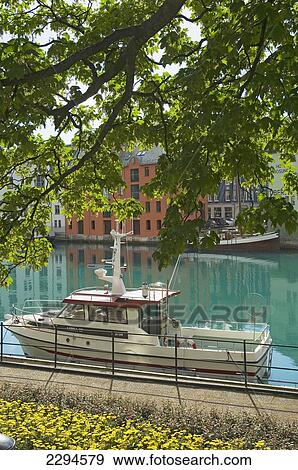 Stock Photo - Norway, More og Romsdal, Boats on canal; Alesund. Fotosearch