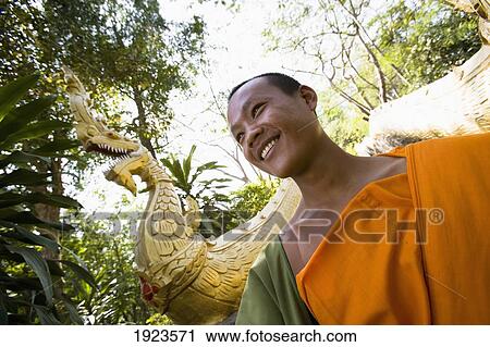 Novice Monk At Foot Of Naga Flanked Staircase On Phu Si Hill, Luang Prabang, Northern Laos View Large Photo Image Stock Image - Novice Monk At Foot Of Naga Flanked Staircase On Phu Si Hill, Luang Prabang, Northern Laos. Fotosearch