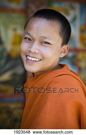 Novice Monk At Wat Naluang, Luang Prabang, Northern Laos View Large Photo Image Stock Photo - Novice Monk At Wat Naluang, Luang Prabang, Northern Laos. Fotosearch