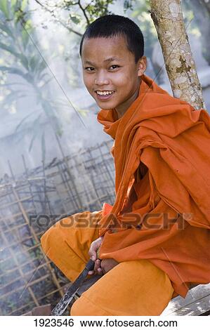 Stock Photograph - Novice Monk At Wat Naluang, Luang Prabang, Northern Laos. Fotosearch