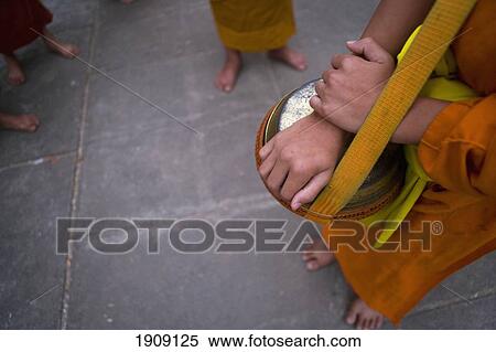 Novice Monks Out Collecting Alms At Dawn In Luang Prabang, Low Section, Laos View Large Photo Image Stock Photography - Novice Monks Out Collecting Alms At Dawn In Luang Prabang, Low Section, Laos. Fotosearch